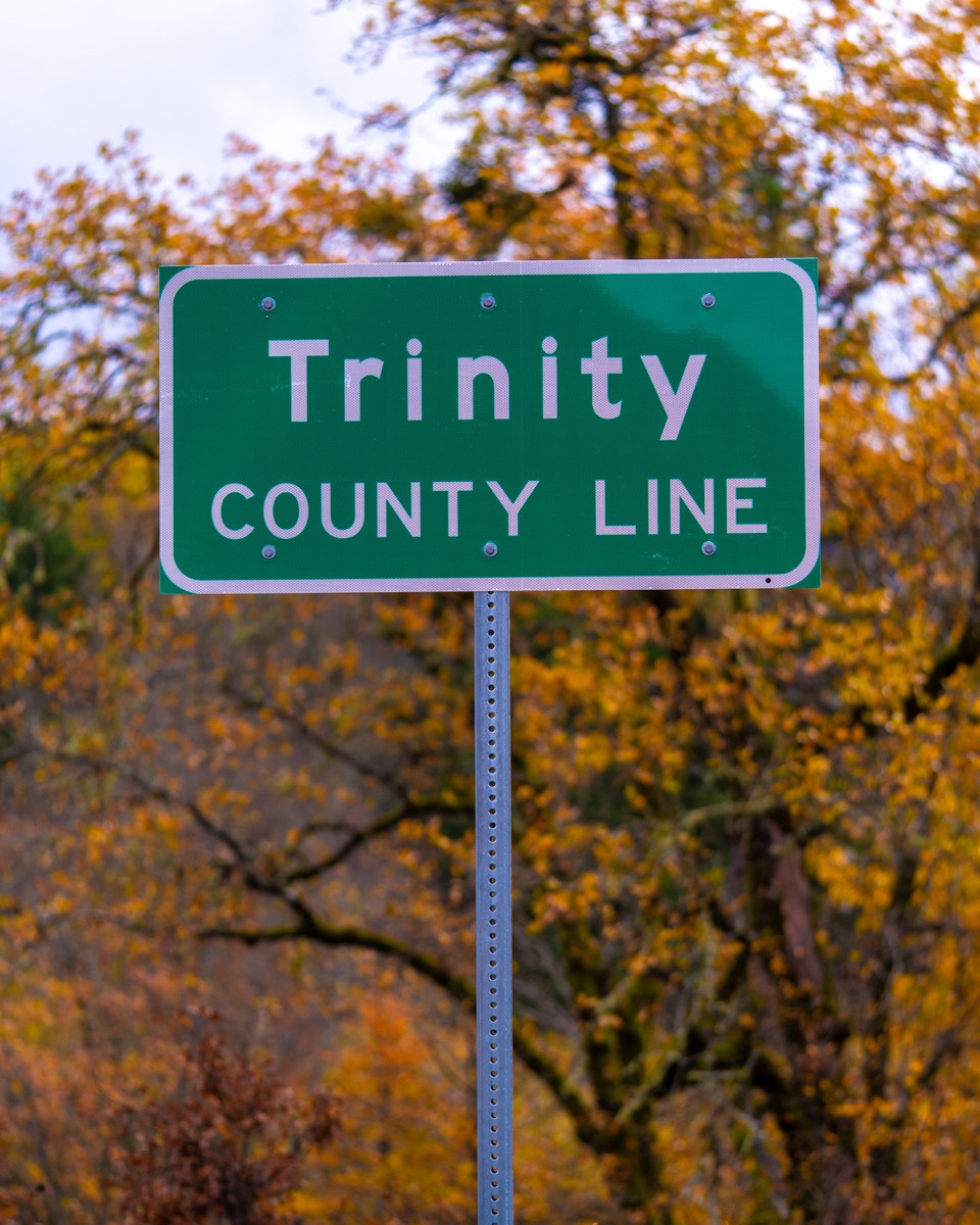 Trinity County Line road sign with fall foliage — the county where Wildcreek Farms operated from 2019 to 2022.